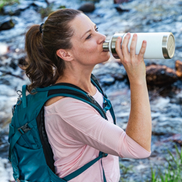 Hiker enjoying cold brew on a mountain trail